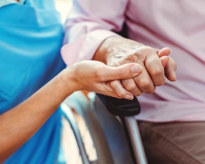 Nurse holding patients hand